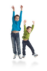 Image showing Two boys jumping on white background.