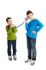 Image showing  Two boys calling tin can phone.