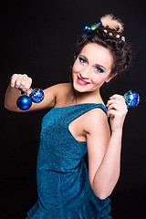 Image showing beautiful girl playing with Christmas decoration