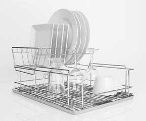 Image showing White dishes drying on metal dish rack