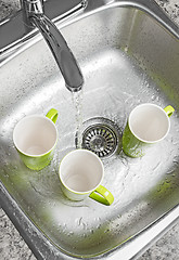 Image showing Washing cups in the kitchen sink