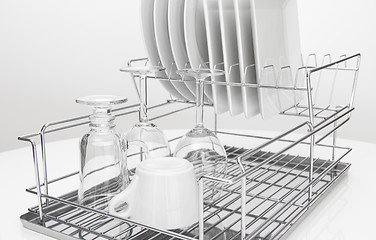 Image showing Metal dish rack with dishes and glasses