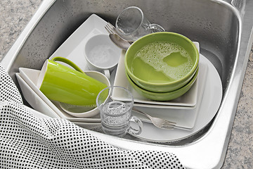 Image showing Bright dishes in the kitchen sink 