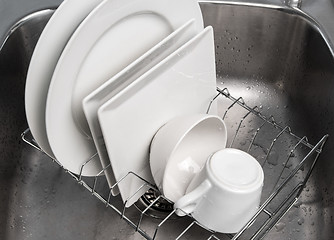 Image showing Dishes drying on a rack in the kitchen sink