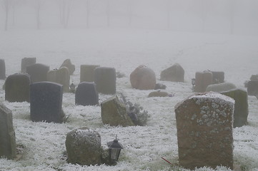 Image showing Snow covered tombstones