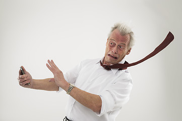 Image showing Businessman being battered by strong winds