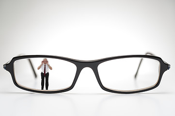 Image showing Diminutive elderly man peering through spectacles