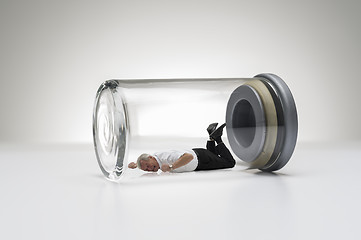 Image showing Senior man trapped in a glass jar