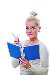 Image showing The young woman looks a note in a notebook