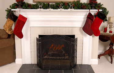 Image showing White fireplace decorated for Christmas