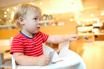 Image showing Little boy in the restaurant.