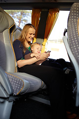 Image showing Mother and kid are playing game on the phone.
