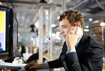 Image showing Working and talking on the phone.