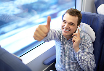 Image showing Young successful businessman in the train.