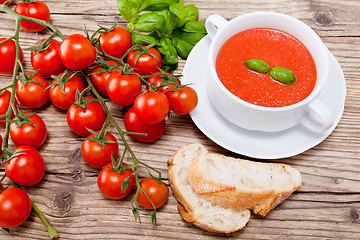 Image showing tasty fresh tomato soup basil and bread