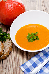 Image showing fresh tasty pumpkin soup and bread