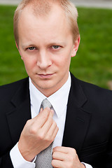 Image showing business man with black suit and tie outdoor