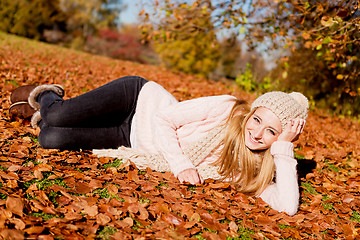 Image showing young woman outdoor in autumn warm clothes