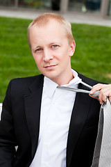 Image showing business man with black suit and tie outdoor