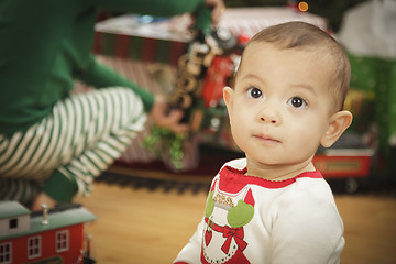 Image showing Infant Baby Enjoying Christmas Morning Near The Tree