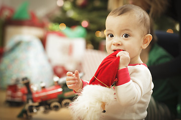 Image showing Infant Baby Enjoying Christmas Morning Near The Tree