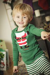 Image showing Young Boy Enjoying Christmas Morning Near The Tree