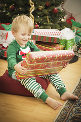 Image showing Young Boy Enjoying Christmas Morning Near The Tree