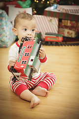 Image showing Infant Baby Enjoying Christmas Morning Near The Tree