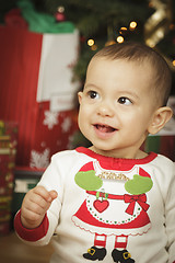 Image showing Infant Baby Enjoying Christmas Morning Near The Tree