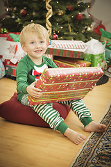 Image showing Young Boy Enjoying Christmas Morning Near The Tree