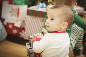 Image showing Infant Baby Enjoying Christmas Morning Near The Tree