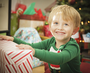 Image showing Young Boy Enjoying Christmas Morning Near The Tree