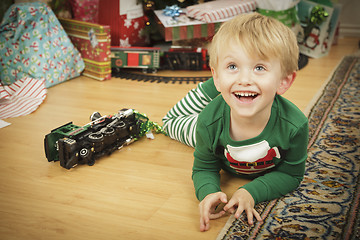 Image showing Young Boy Enjoying Christmas Morning Near The Tree