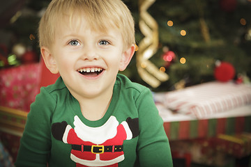 Image showing Young Boy Enjoying Christmas Morning Near The Tree