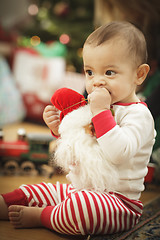 Image showing Infant Baby Enjoying Christmas Morning Near The Tree