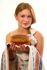 Image showing A young girl with fresh bread in the hands of