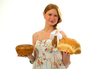 Image showing A young girl with fresh bread in the hands of