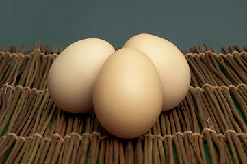 Image showing Raw eggs on wooden base