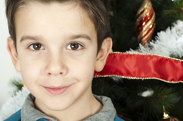 Image showing Happy children in front of Christmas tree