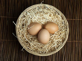 Image showing Raw eggs in a wicker basket