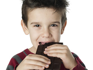 Image showing Smiling kid eating chocolate