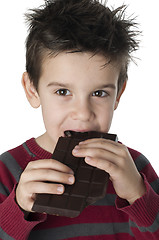 Image showing Smiling kid eating chocolate