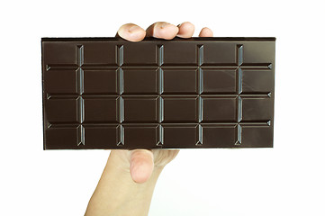 Image showing Hand holding chocolate bar