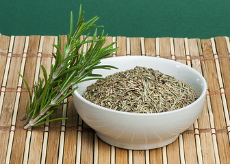 Image showing Fresh rosemary and a bowl with dried