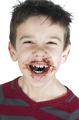 Image showing Smiling little boy eating chocolate