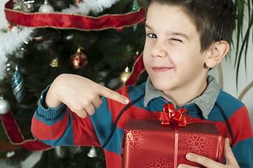 Image showing Boy points out his gift on Christmas