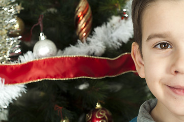 Image showing Happy children in front of Christmas tree