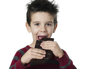 Image showing Smiling kid eating chocolate