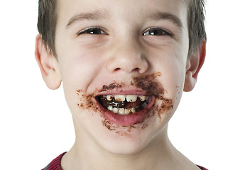 Image showing Smiling little boy eating chocolate