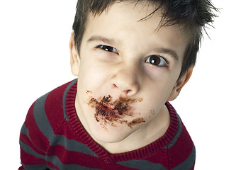 Image showing Smiling little boy eating chocolate